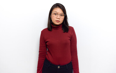 Looking at camera with sad face of Young beautiful asian women dress red shirt isolated on white background