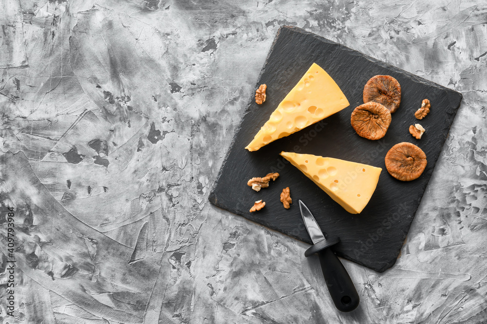 Composition with pieces of tasty cheese on grunge background