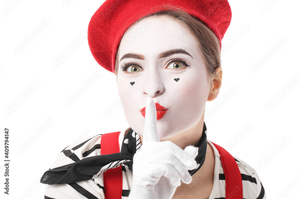 Female pantomimist showing silence gesture on white background