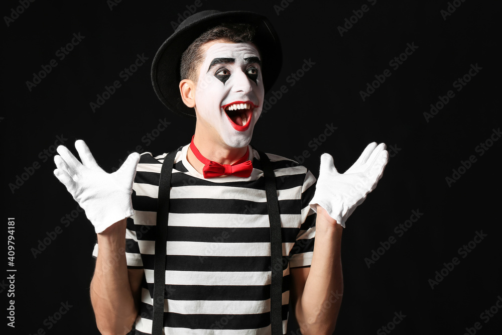 Male pantomimist on dark background