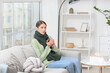© Pixel-Shot - Sick young woman drinking hot tea at home