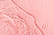 Transparent and clean pink water background with sunlight reflection