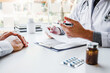 © joyfotoliakid - Doctor or physician recommend pills medical prescription to male Patient