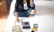 selective focus of woman hand with calculator  and credit cards which she is  unemployment and personal bankruptcy in the bed room