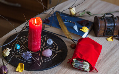 Altar with a pentagram to attract love, happiness, candle, stones, Tarot cards and witchcraft at home