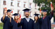 © Syda Productions - education, graduation and school concept - happy smiling male graduate student in mortar board and bachelor gown with diploma over group of people on campus background