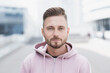 © kite_rin - Closeup portrait of handsome serious young man on a city street, Cheerful smiling young men looking at camera at urban background.