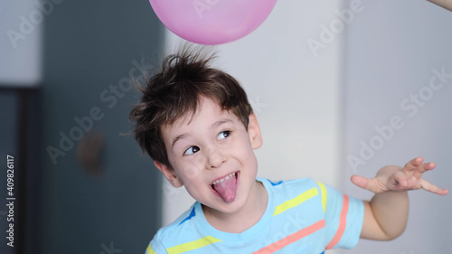 surprised cheerful boy with thorns in his hair without static electrification. Physics, electrical electrification balloon test. Positively and negatively charged atoms. School lesson experiment.
