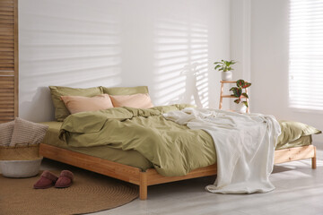 Poster - Large bed with soft blanket in stylish room interior