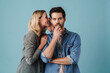 © Drobot Dean - Young beautiful woman whispering secret at surprised guy
