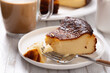 Delicious basque cheesecake portion with a coffee