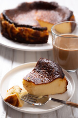 Wall Mural - Classic basque cheesecake with a coffee