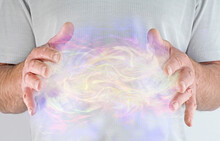 High Resonance White Light Healing Energy Phenomenon  - Male Healer With Hands Apart At Chest Level Sensing A Phenomenal  Multicoloured Shimmering Paranormal Energy Field 
