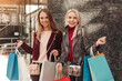 © kegfire - Joyful young girlfriends enjoying shopping time