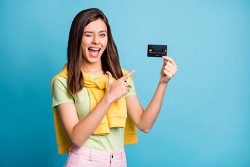 Wall Mural - photo of funny charming person eye wink indicate finger debit card open mouth isolated on blue color