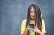 Happy millennial girl using mobile phone app for social media