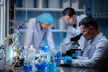 Wall Mural - scientist working with microscope in laboratory, medical science research