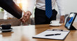 Successful negotiation and shake hand after success in sign business contract