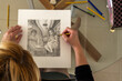 © Nemesio - Close-up of hands making a figurative drawing in black and white