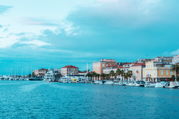 Wall Mural - View of Zadar city embankment with residential buildings, palm trees and moored boats, Croatia