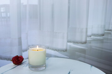 Wall Mural - The luxury lighting aromatic scented glass candle diplay on the white marble table in the white bedroom with background of the curtain to creat romantic and relax ambient on Valentine day