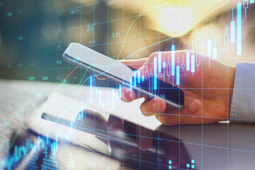 Poster - Hands using smartphone with candlestick stock charts.