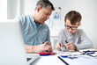 © epiximages - Father and son repairing an electrical outlet.
