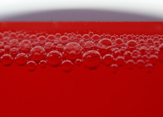 Canvas Print - Macro shot of soap bubbles on red background