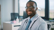 © Gorodenkoff - Portrait of African American Family Medical Doctor in Glasses is Working in a Health Clinic. Successful Black Physician in White Lab Coat Looks at the Camera and Smiles in Hospital Office.