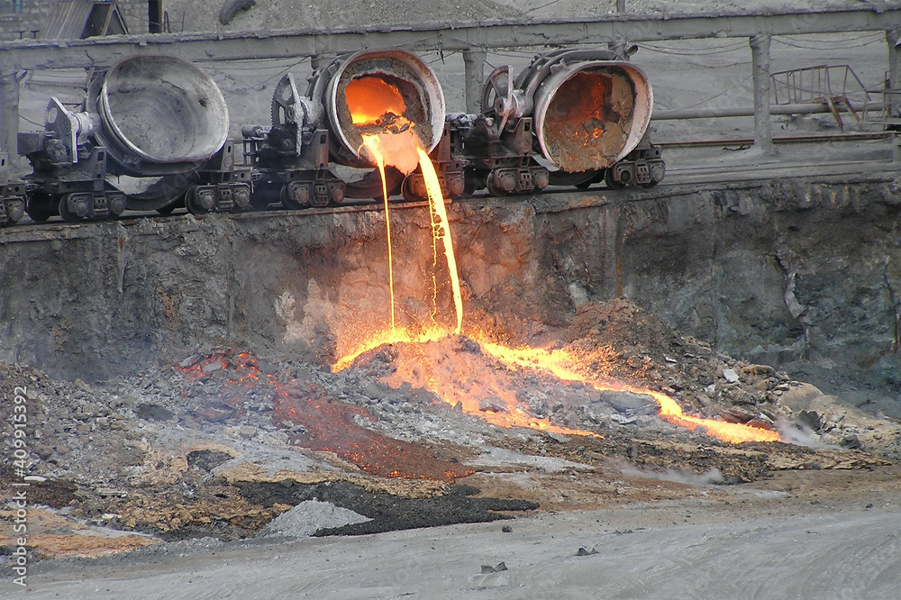 Slagger Pouring out the remains of blast furnace slag from the slag truck ...