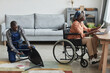 © Seventyfour - Full length portrait of African-American man assembling furniture in home interior with woman in wheelchair working at desk, handyman service and assistance concept, copy space