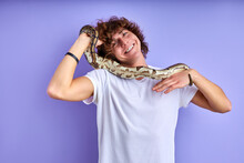 Positive Male Holding Snake In Hands, Doesn't Afraid, No Phobia. Caucasian Male In White T-shirt Posing With Snake