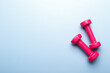 © Lana_M - Pink dumbbells on blue background