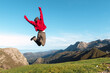 © Alberto Menendez/ADDICTIVE STOCK - Back view of excited hiker jumping above ground in highlands and enjoying summer vacation in El Mazuco