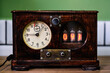 © Antonio Ovejero/ADDICTIVE STOCK - Vintage wooden steampunk clock with lamp indicators and round dial  placed on table