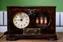 Vintage Wooden Steampunk Clock With Lamp Indicators And Round Dial  Placed On Table