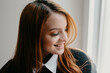 © Daniel Sierralta/ADDICTIVE STOCK - Positive young female with long red hair and perfect skin sincerely smiling and looking away