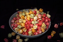 Tasty Colorful Popcorn In Bowl Placed On Black Background In Studio