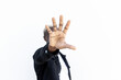 © David Munoz/ADDICTIVE STOCK - Anonymous African American male in casual outfit reaching hand toward camera and covering face while standing on street and showing stop gesture
