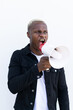 © David Munoz/ADDICTIVE STOCK - African American male shouting in loudspeaker while standing on white background