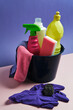 © Fatima Guisado/ADDICTIVE STOCK - Assorted plastic bottles and cleaning products arranged on table in studio on purple background