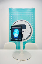 Modern Facial Skin Diagnostics Equipment With Tablet Placed On Table In White Room In Beauty Clinic
