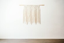 Eco Friendly Boho Style Cotton Macrame Decoration On Wooden Stick Hanging On White Wall In Light Room With Minimalist Interior