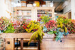 © Javier Ballester/ADDICTIVE STOCK - Wooden table at floristry workshop full of flowers for arrangements