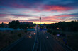 © Javier Martinez/ADDICTIVE STOCK - Scenery of endless roadway with driving cars under colorful sunset sky in Madrid