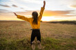 © Jordi Bataller/ADDICTIVE STOCK - Back view os unrecognizable carefree female in casual outfit in moment of jumping above ground in meadow on background of sunset in rural area