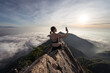 © Juan Alberto Ruiz/ADDICTIVE STOCK - Back view of female ethnic hiker sitting on top of Yuanzui Mountain and taking self portrait on smartphone