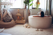 © Juan Alberto Ruiz/ADDICTIVE STOCK - Happy young Asian woman enjoying bath time in bathtub in hotel room with traditional oriental decor while spending holidays in Taiwan