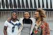 © Julio Rodriguez/ADDICTIVE STOCK - Group of cheerful young African American hipster friends in trendy outfits looking at camera and smiling happily on urban street