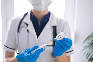 Doctor, nurse, scientist hand in blue gloves holding flu, measles, coronavirus, covid-19 vaccine disease preparing for child, baby, adult, man and woman vaccination shot, medicine and drug concept.